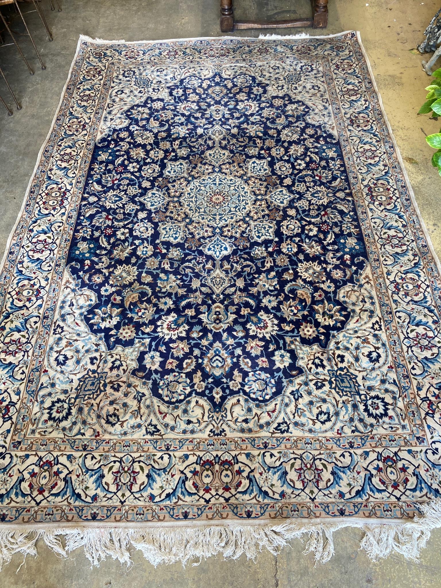 A North West Persian ivory ground carpet, 325 x 203cm